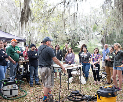 Spectators gathered around a live outdoor demonstration