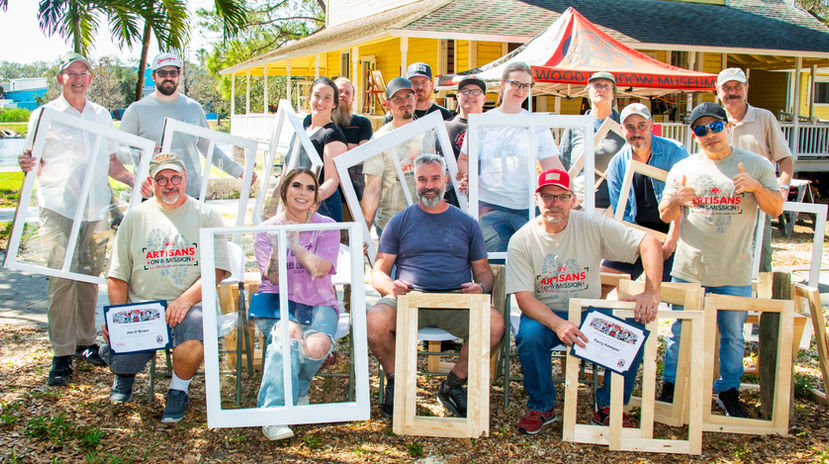 Workshop group holding their finished sash outdoors