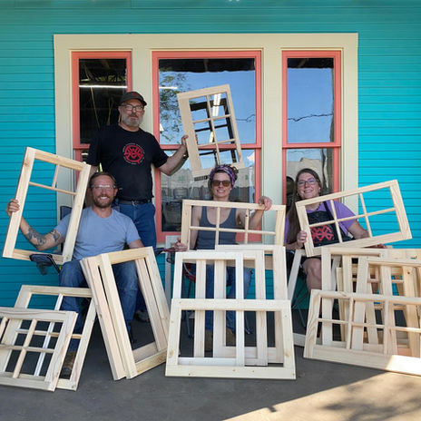 Students displaying window sash they built