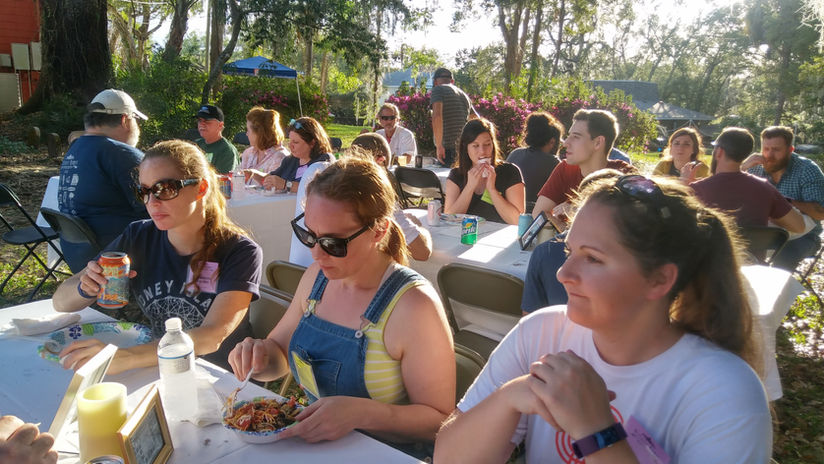 Participants sharing a community lunch outdoors
